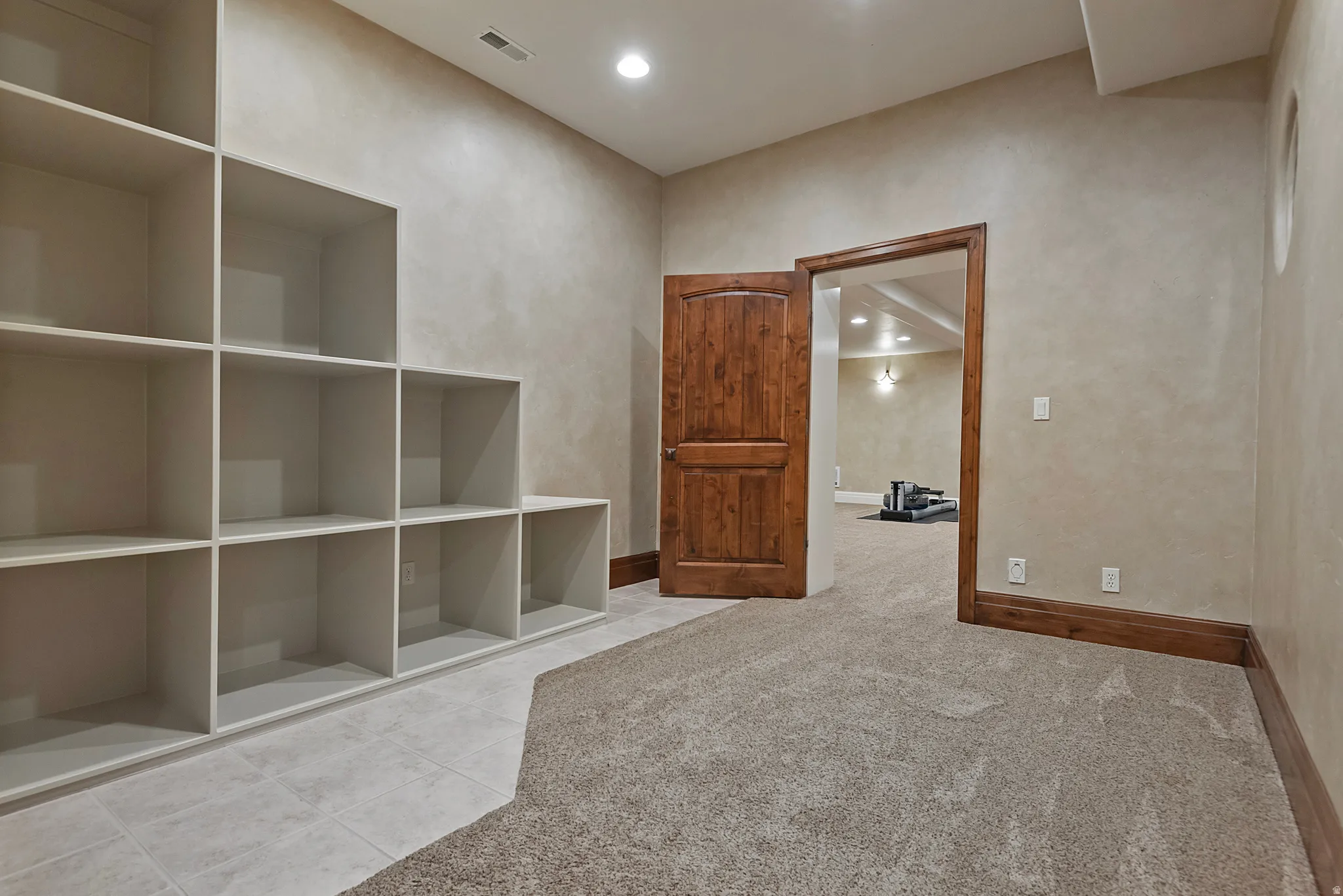 Interior space featuring light carpet, recessed lighting, and light tile patterned floors