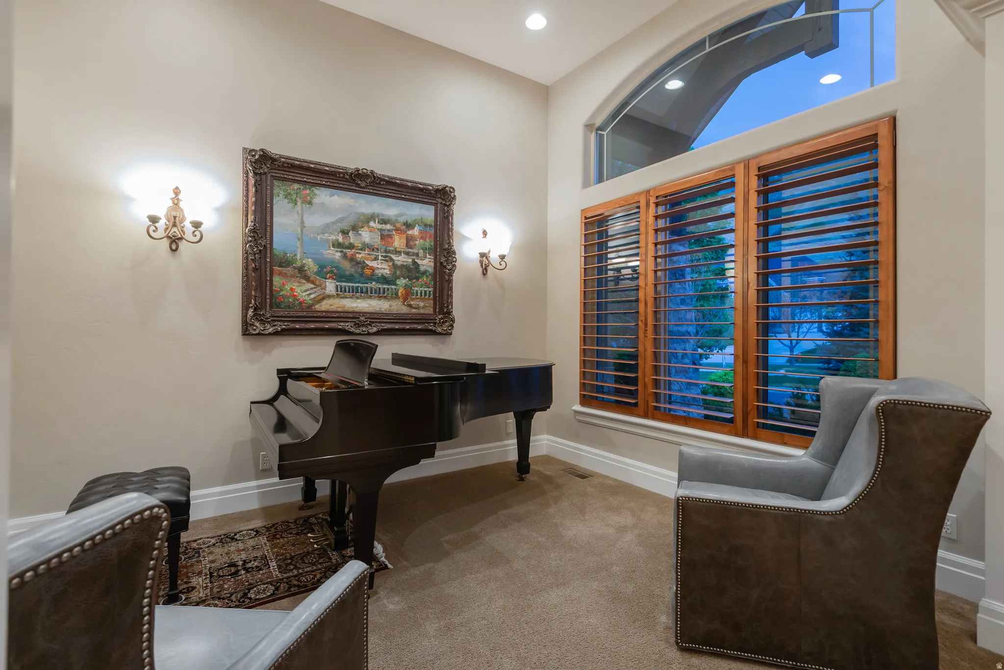 Sitting room with light colored carpet and recessed lighting