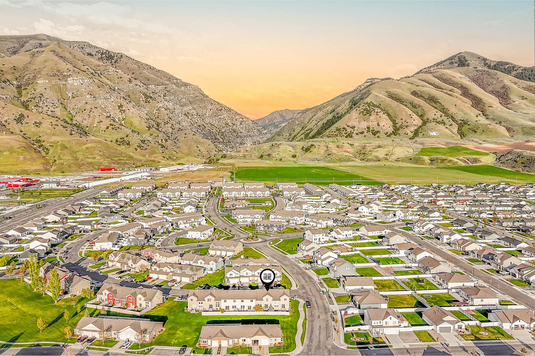 Aerial perspective of suburban area featuring a mountainous background
