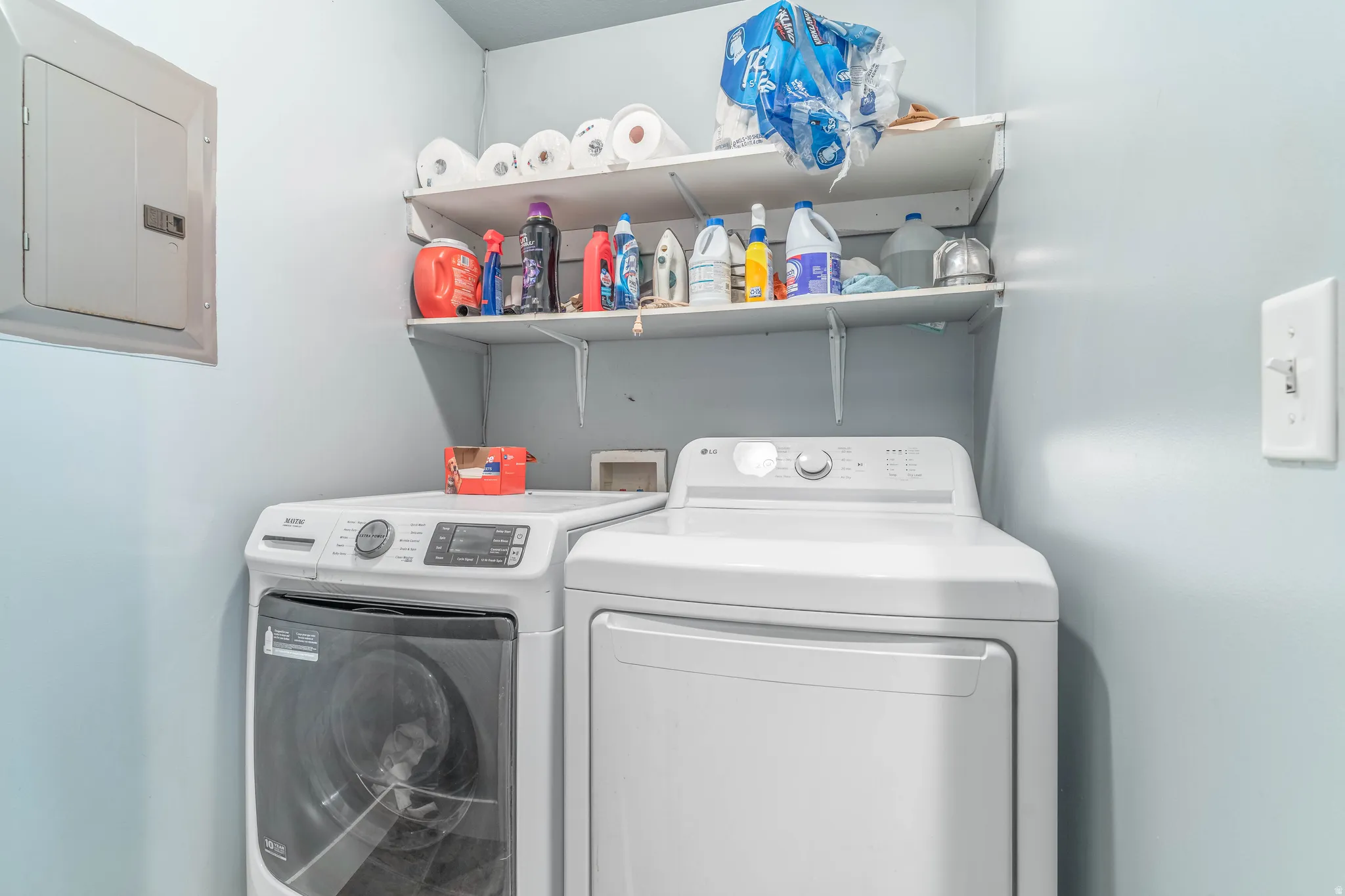 Laundry area with electric panel and independent washer and dryer