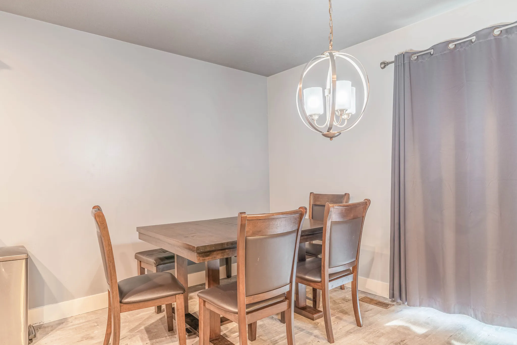 Dining area featuring suspended lighting and baseboards