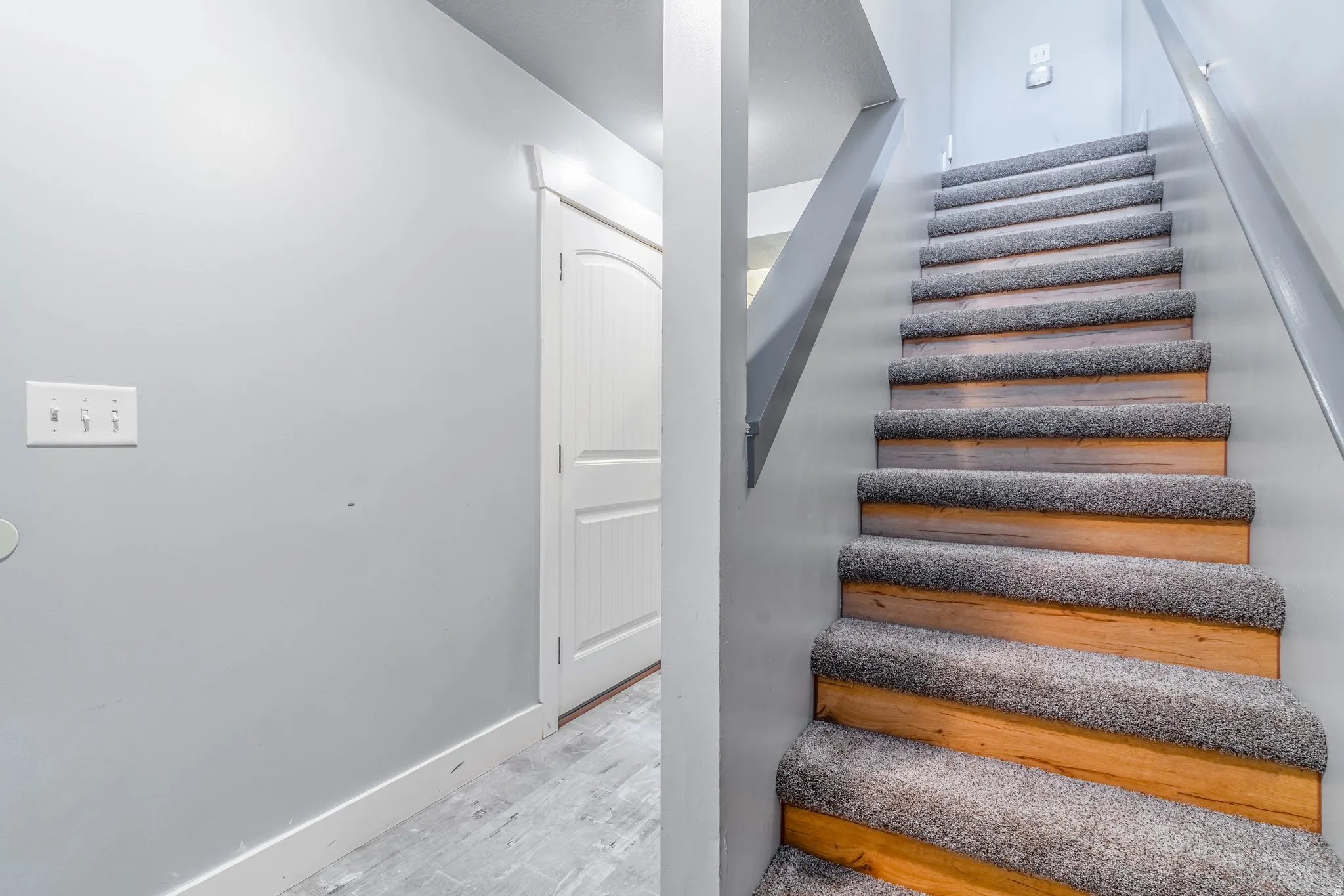 Stairway featuring baseboards and wood finished floors