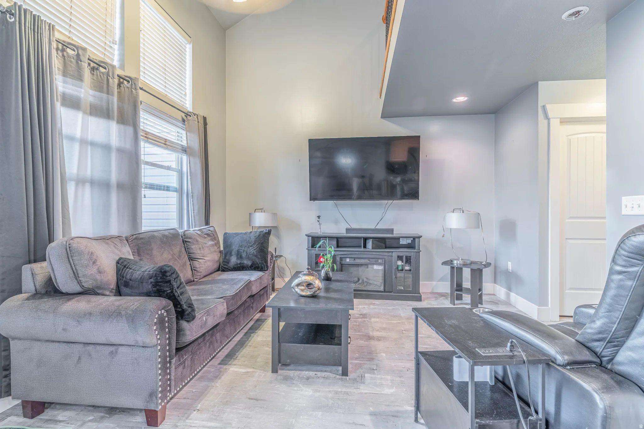 Living room with a high ceiling and recessed lighting