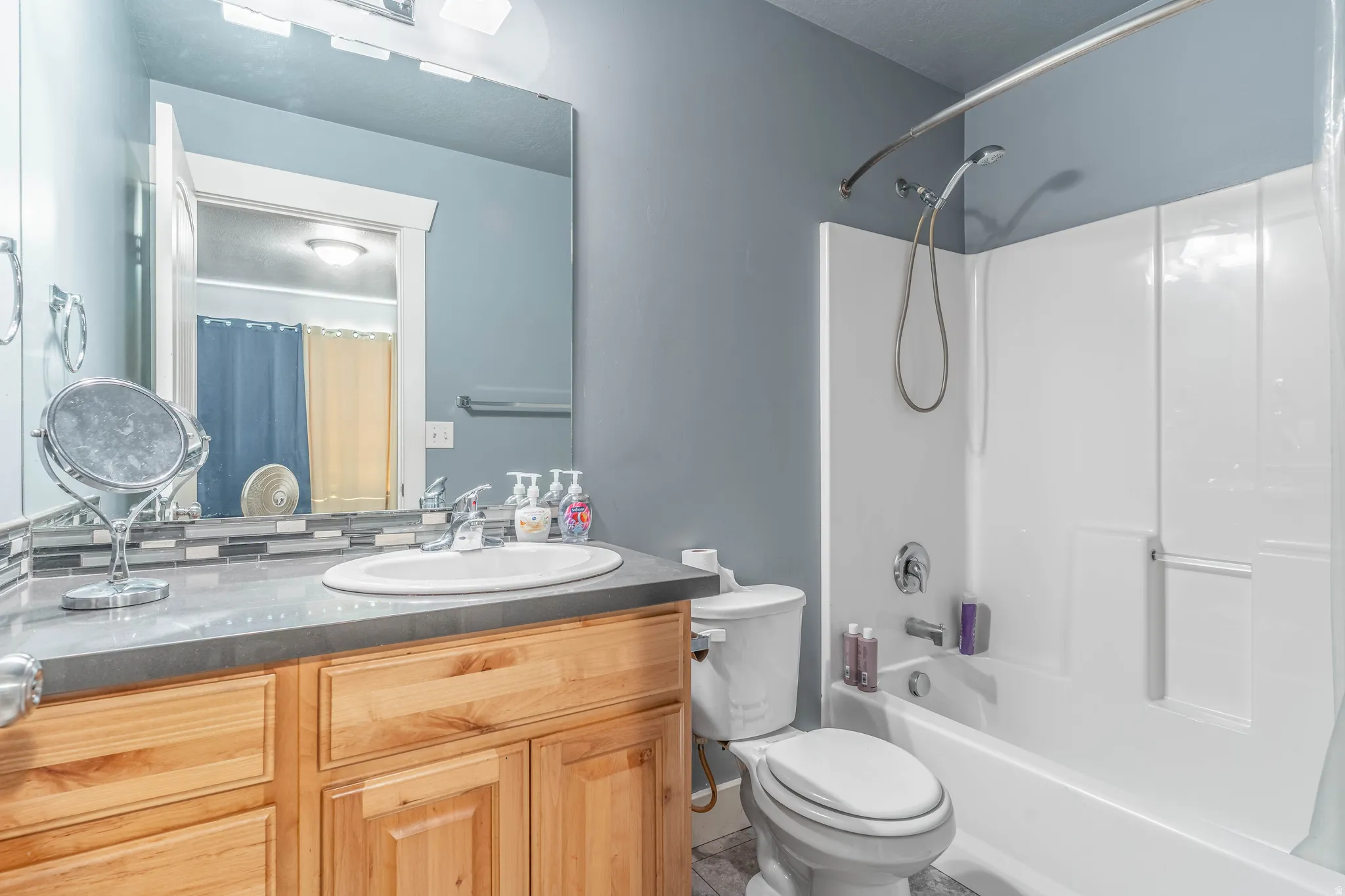 Bathroom featuring vanity and shower / bath combo with shower curtain