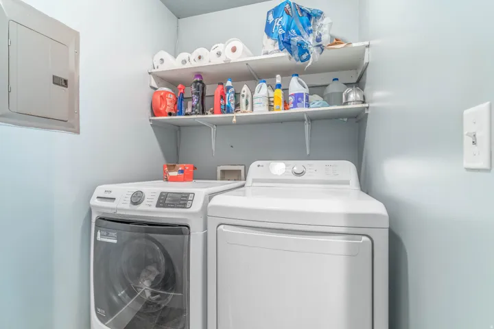 Laundry area with electric panel and independent washer and dryer