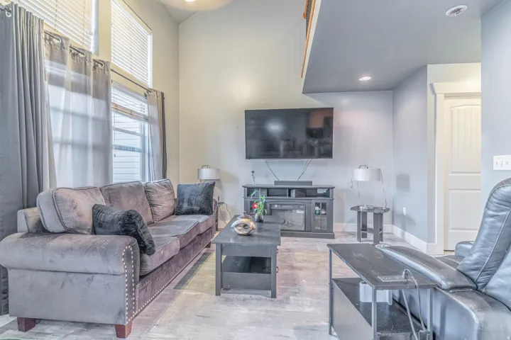 Living room with a high ceiling and recessed lighting