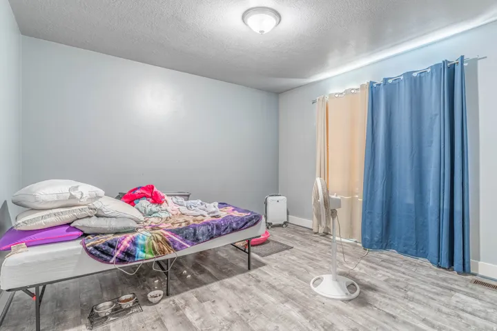 Bedroom featuring a textured ceiling and light wood-style floors