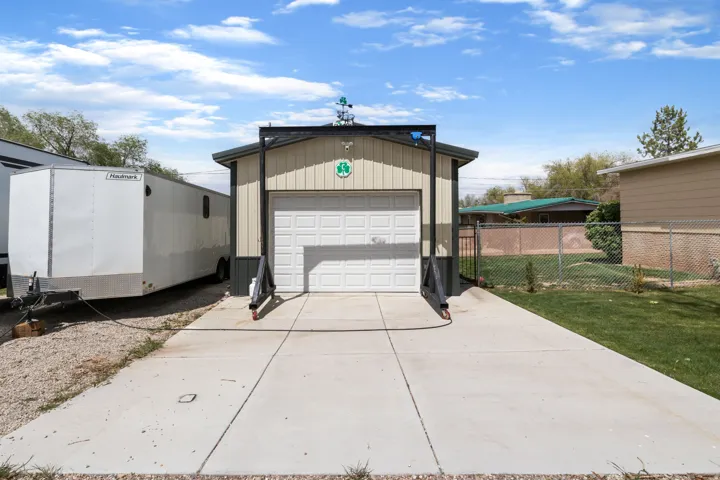 Detached garage featuring concrete driveway