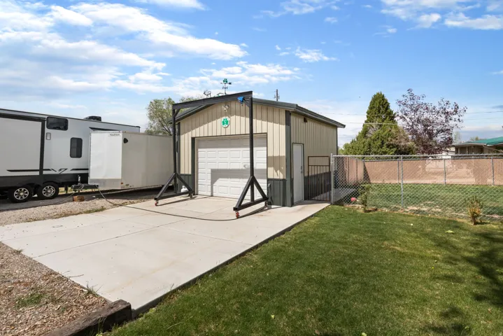 View of outdoor structure with concrete driveway