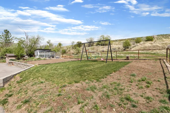 View of yard with a sunroom, a playground, and a view of countryside