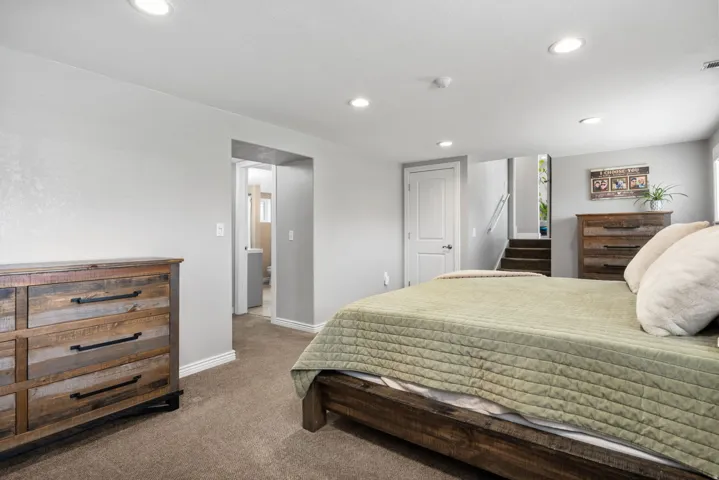 Carpeted bedroom featuring recessed lighting and baseboards