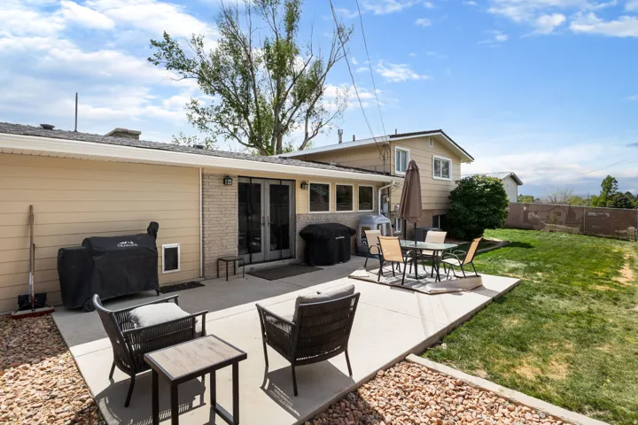 Rear view of property with brick siding, a patio area, french doors, and outdoor dining space