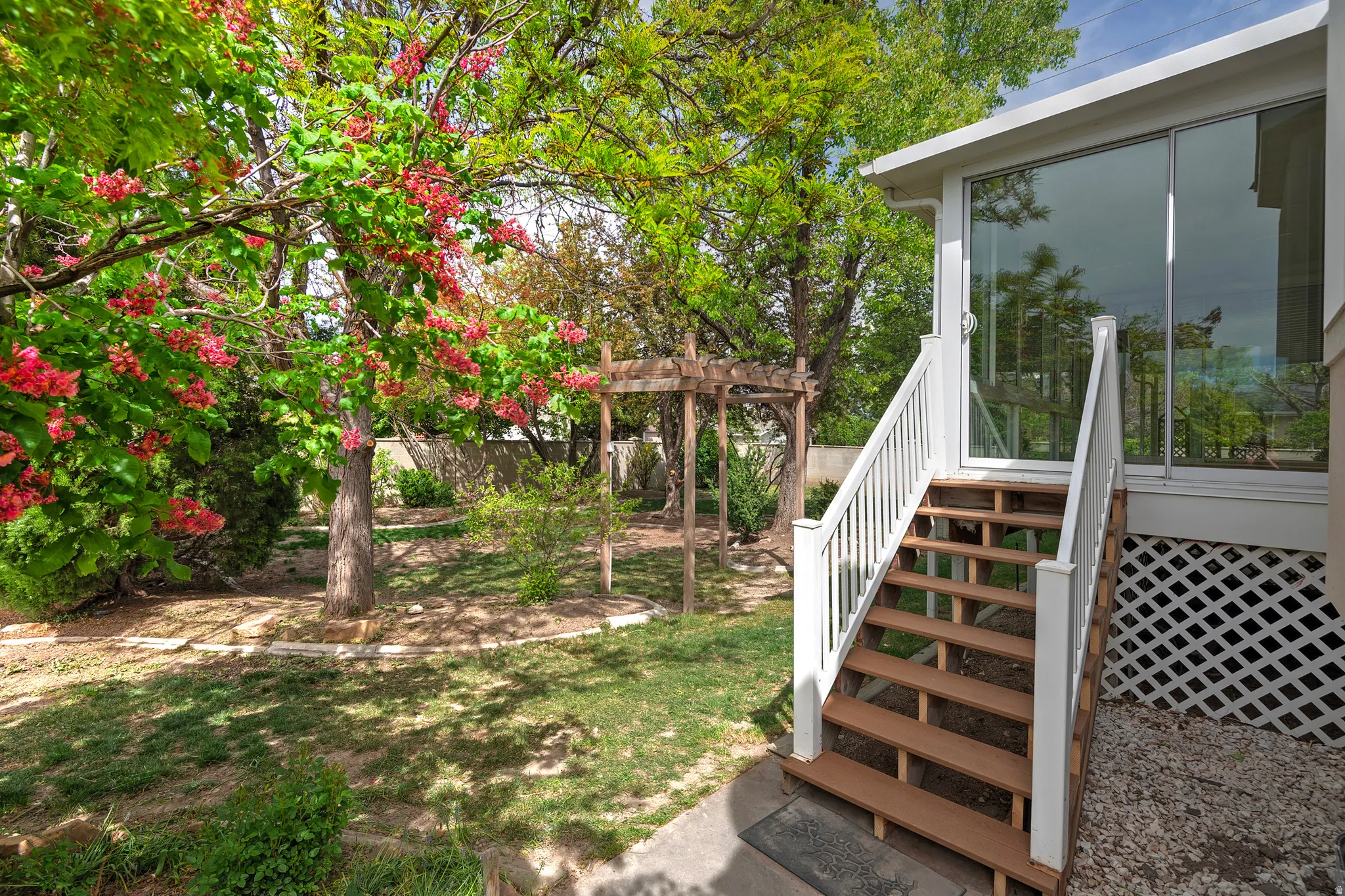 Fenced yard with stairway and a sunroom