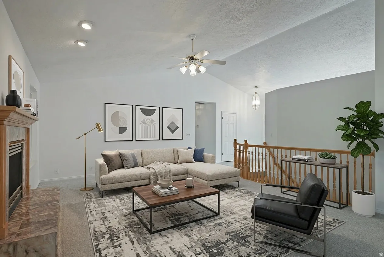 Carpeted living area with a fireplace with raised hearth, a ceiling fan, and a textured ceiling