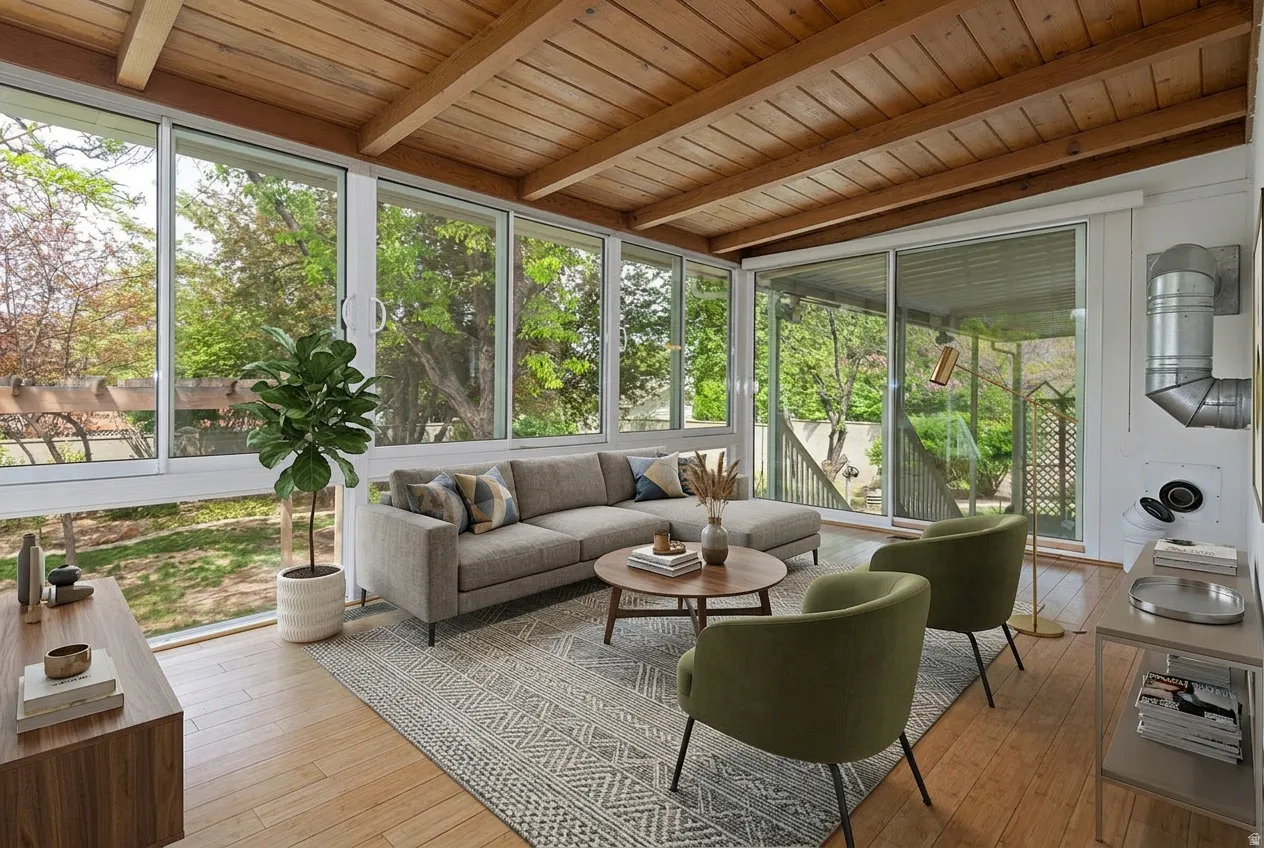 Sunroom / solarium featuring beam ceiling, healthy amount of natural light, and an outdoor living space