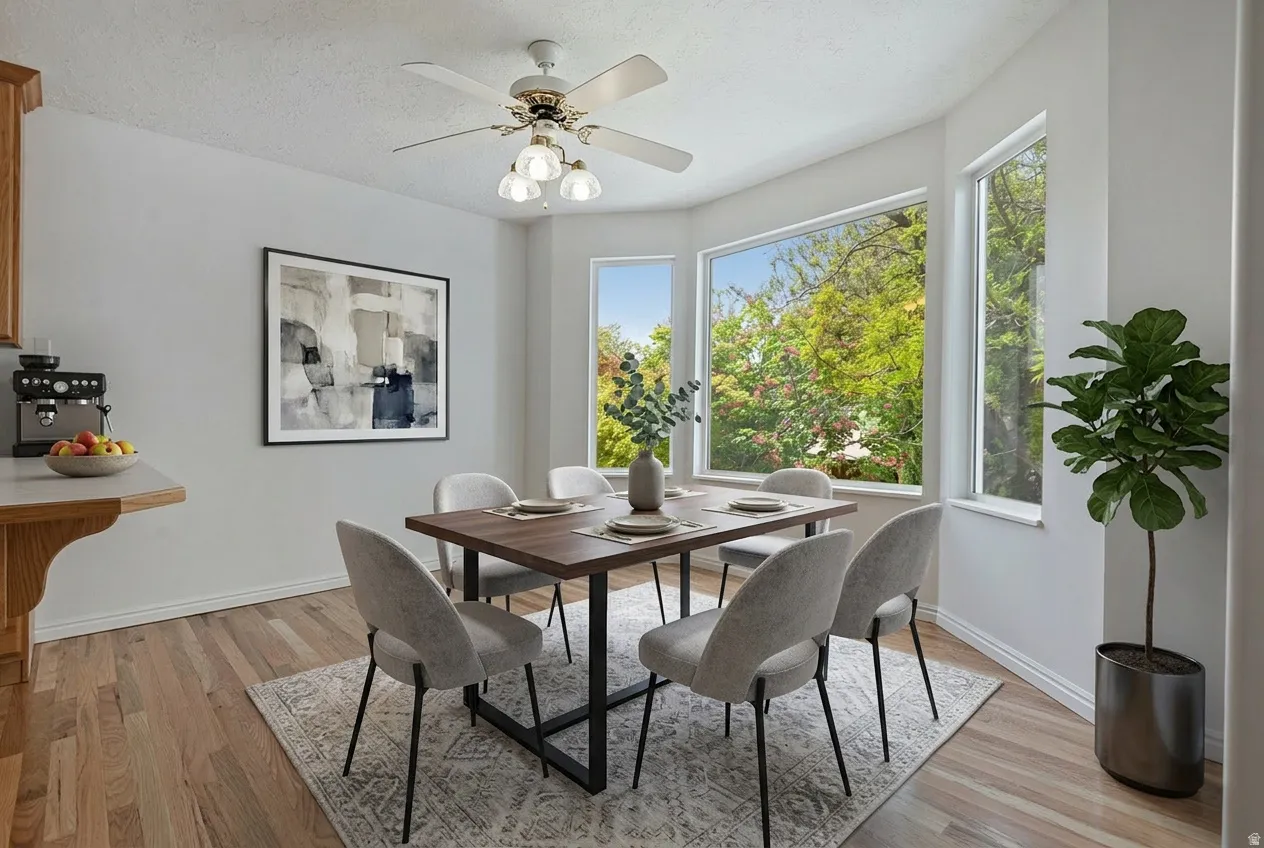 Dining area featuring light wood-style flooring, healthy amount of natural light, and a ceiling fan