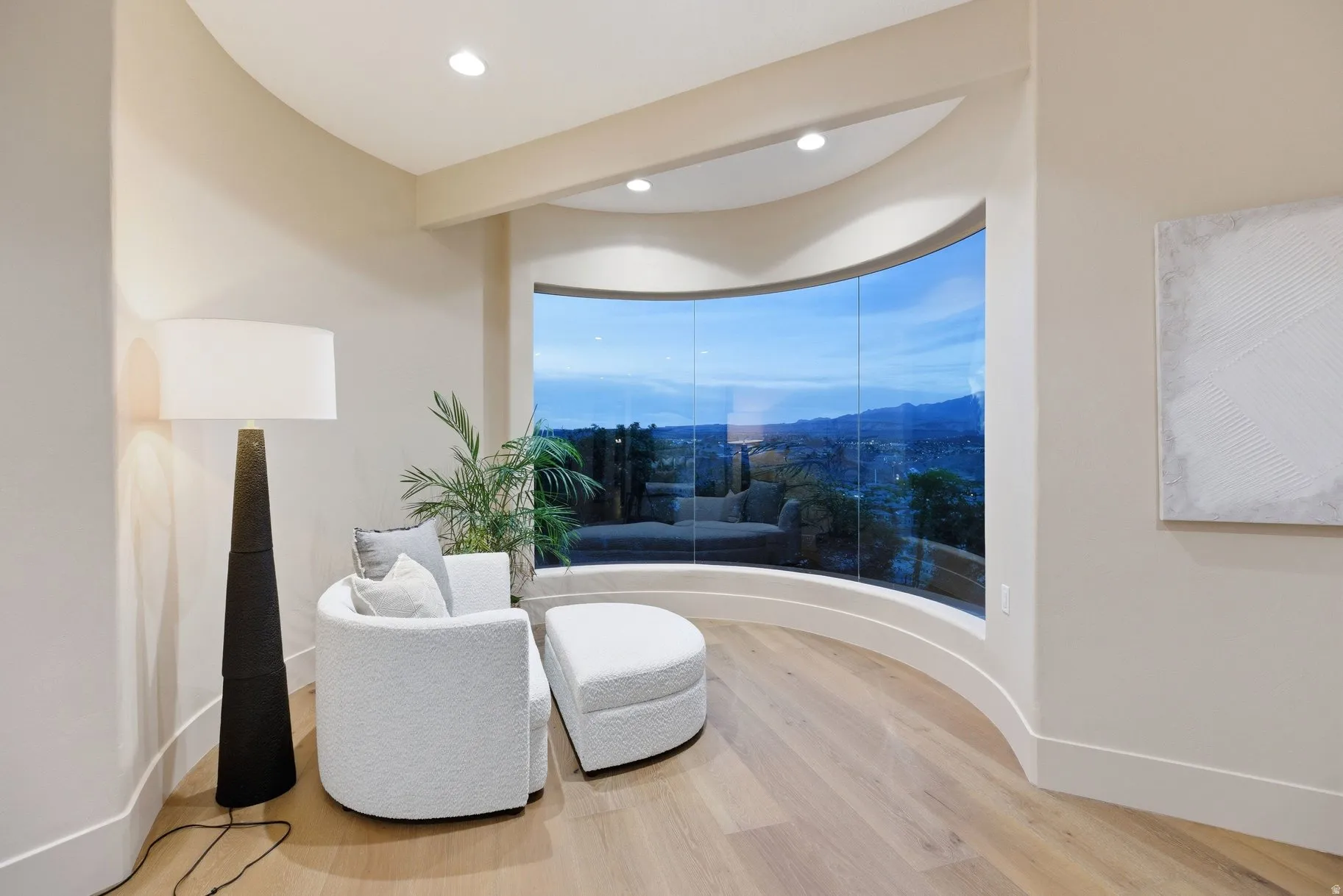 Living area featuring light wood finished floors and recessed lighting