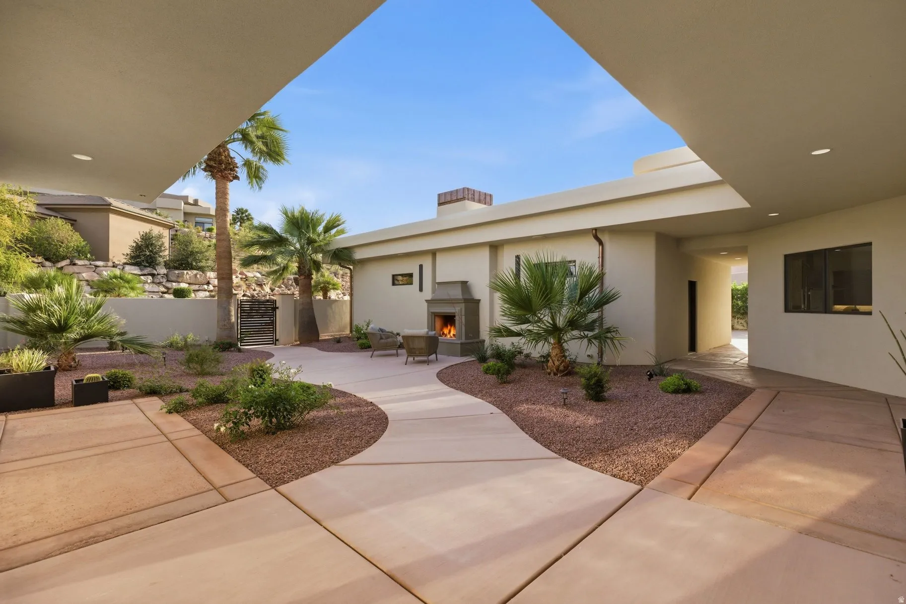 View of patio / terrace with a warm lit fireplace