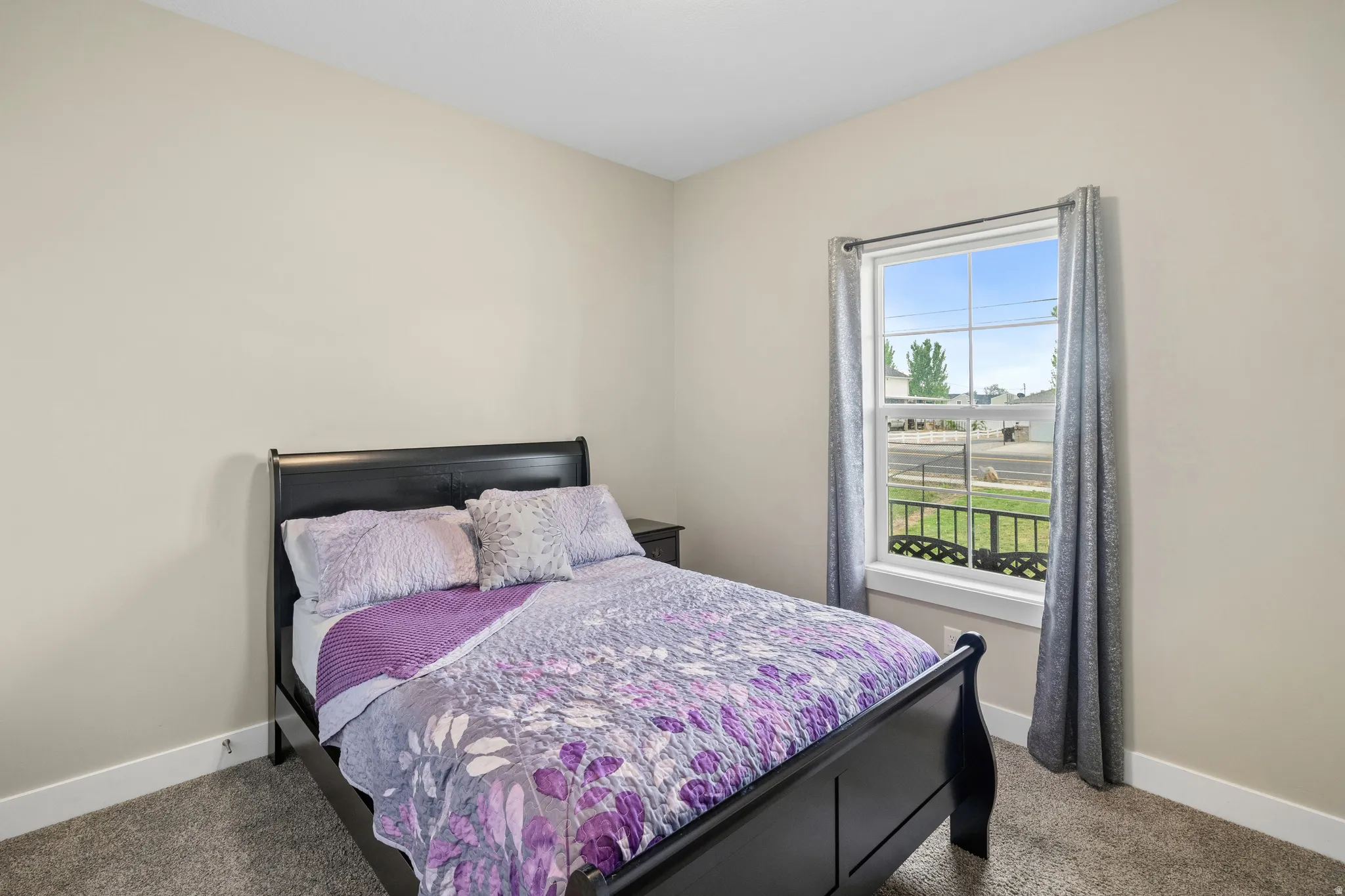 Carpeted bedroom featuring baseboards