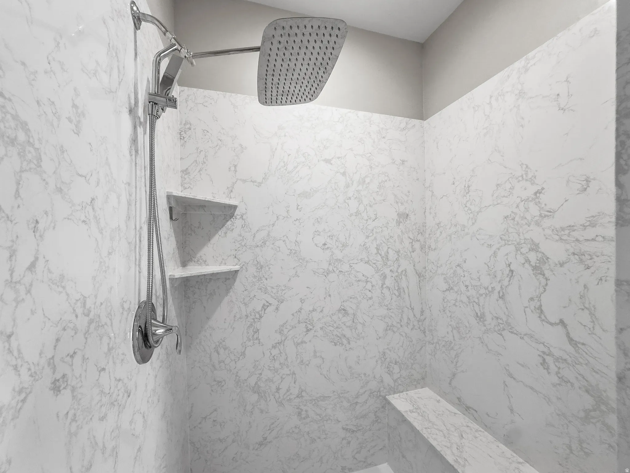 Bathroom view of a marble finish shower