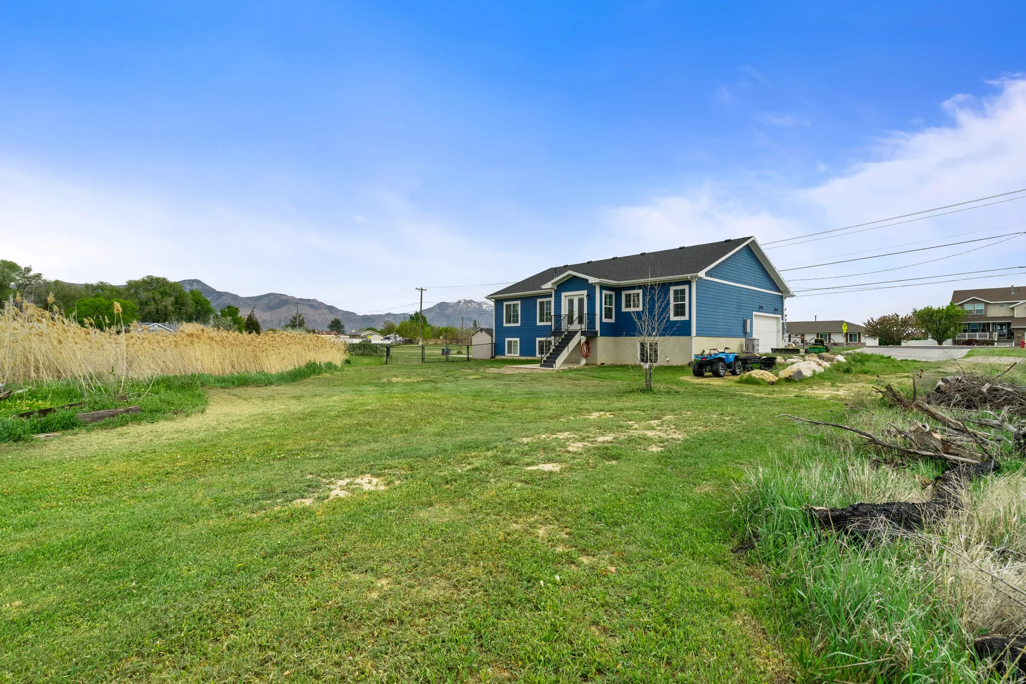 Rear view of house with a yard and a mountain view