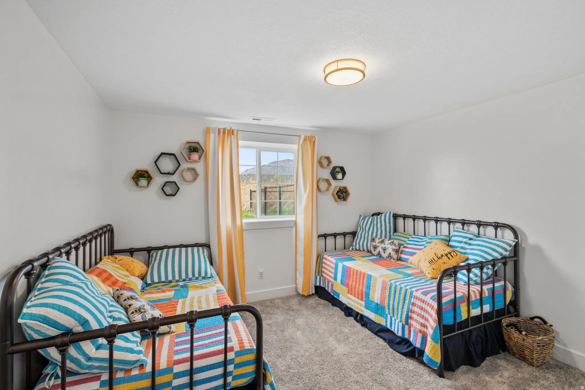 Bedroom with light carpet and a mountain view