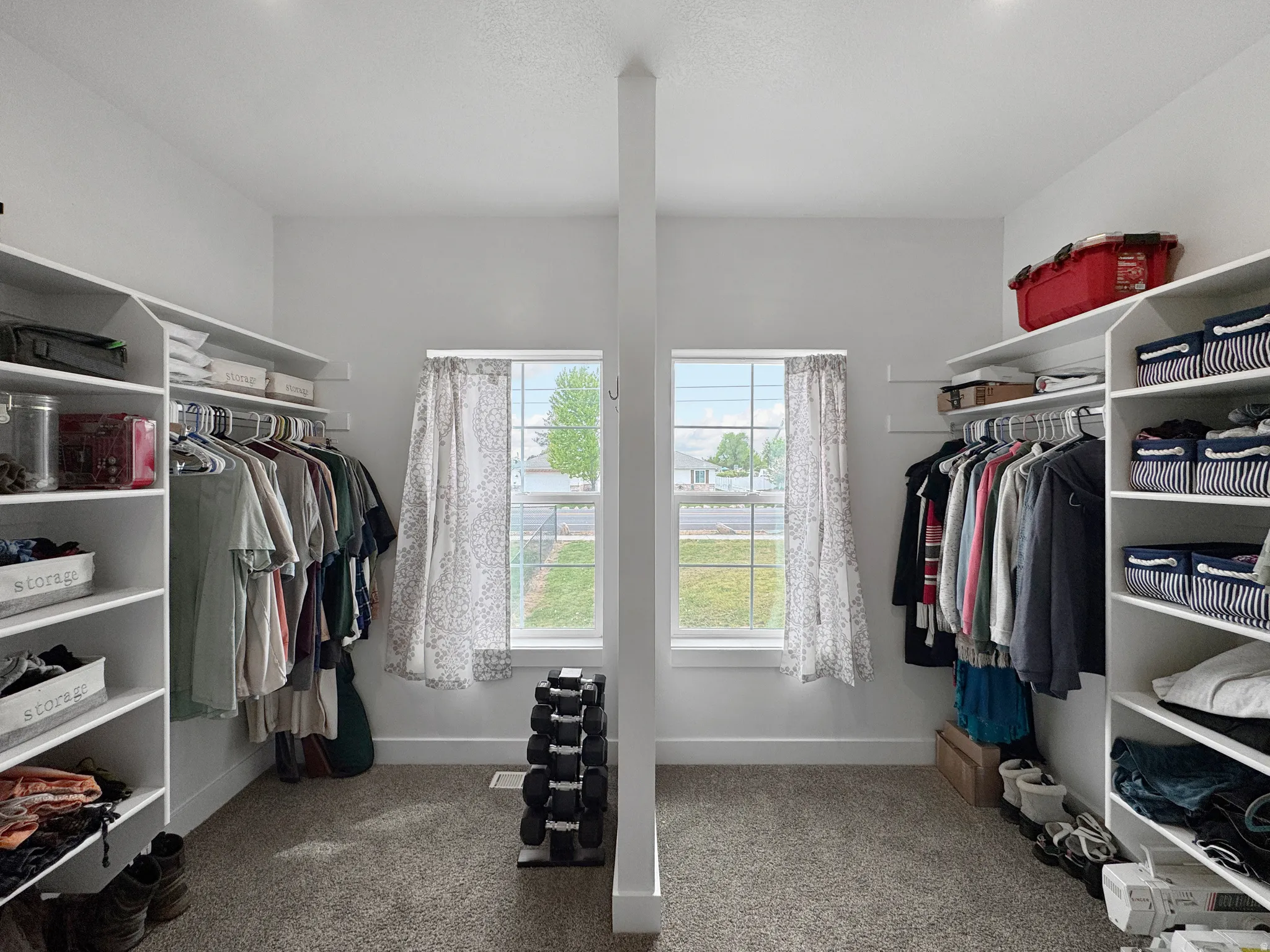Walk in closet with light colored carpet