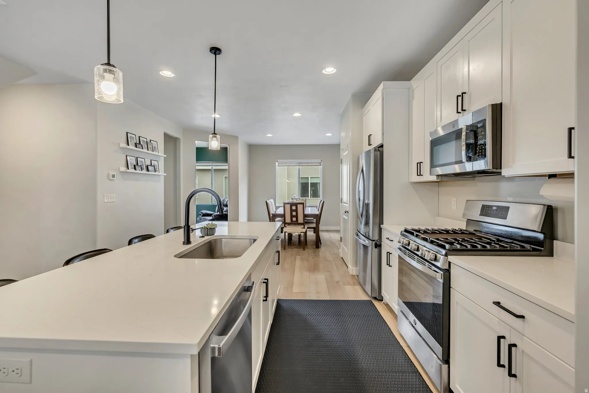 Kitchen view into the dining room area and office or den.