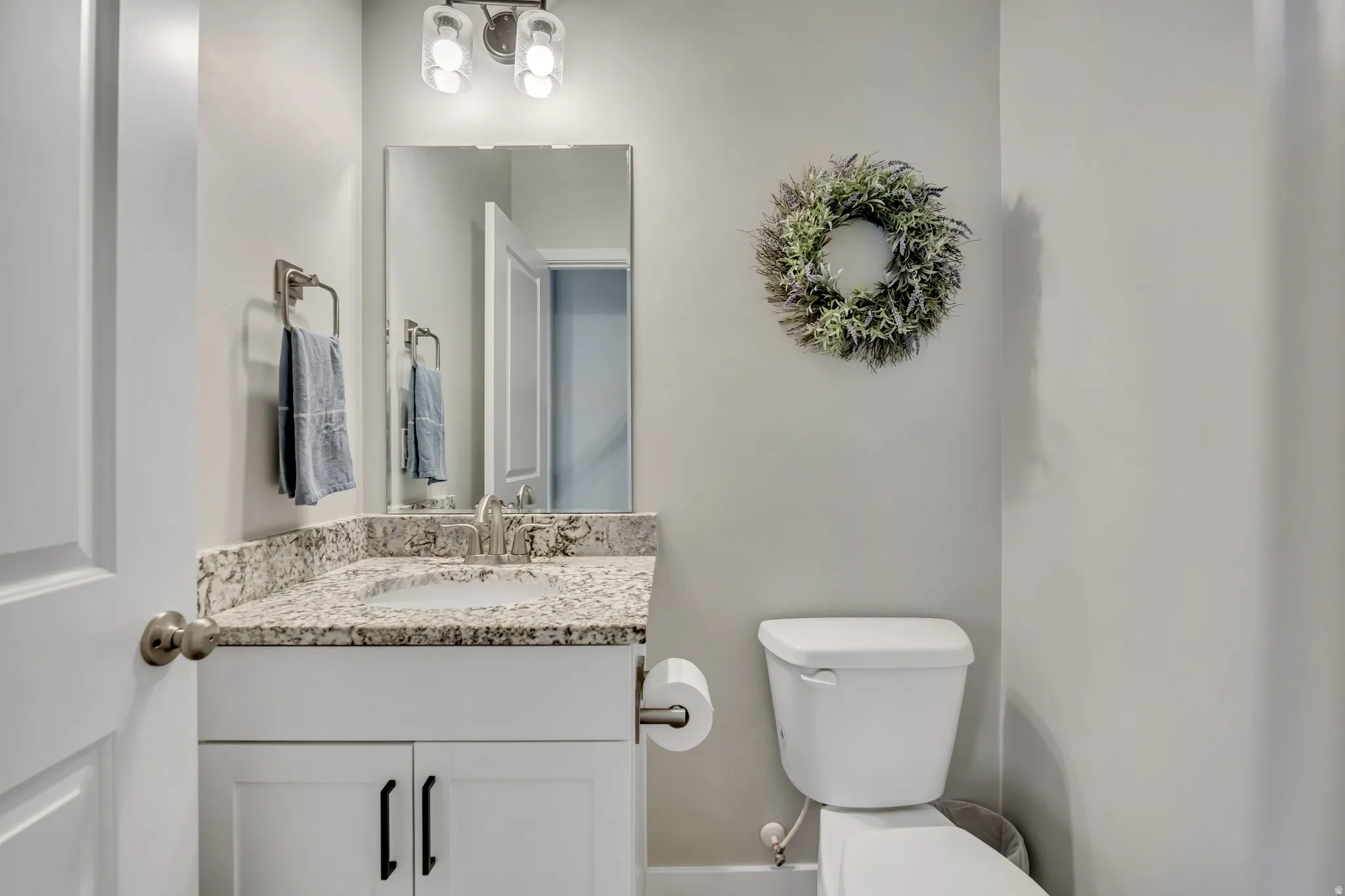 Half bath with toilet and vanity.