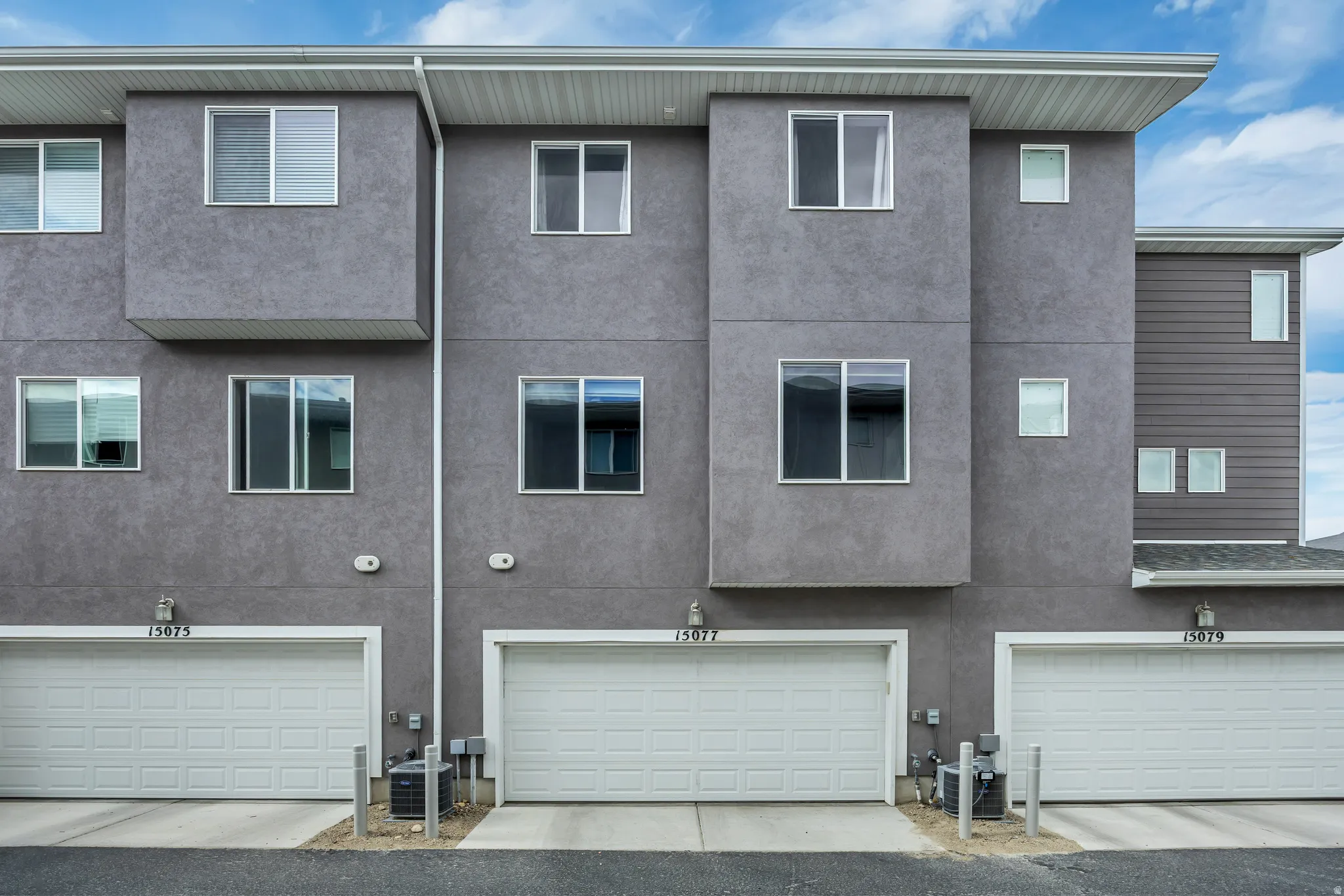 Back of the home with 2-car garage entry.