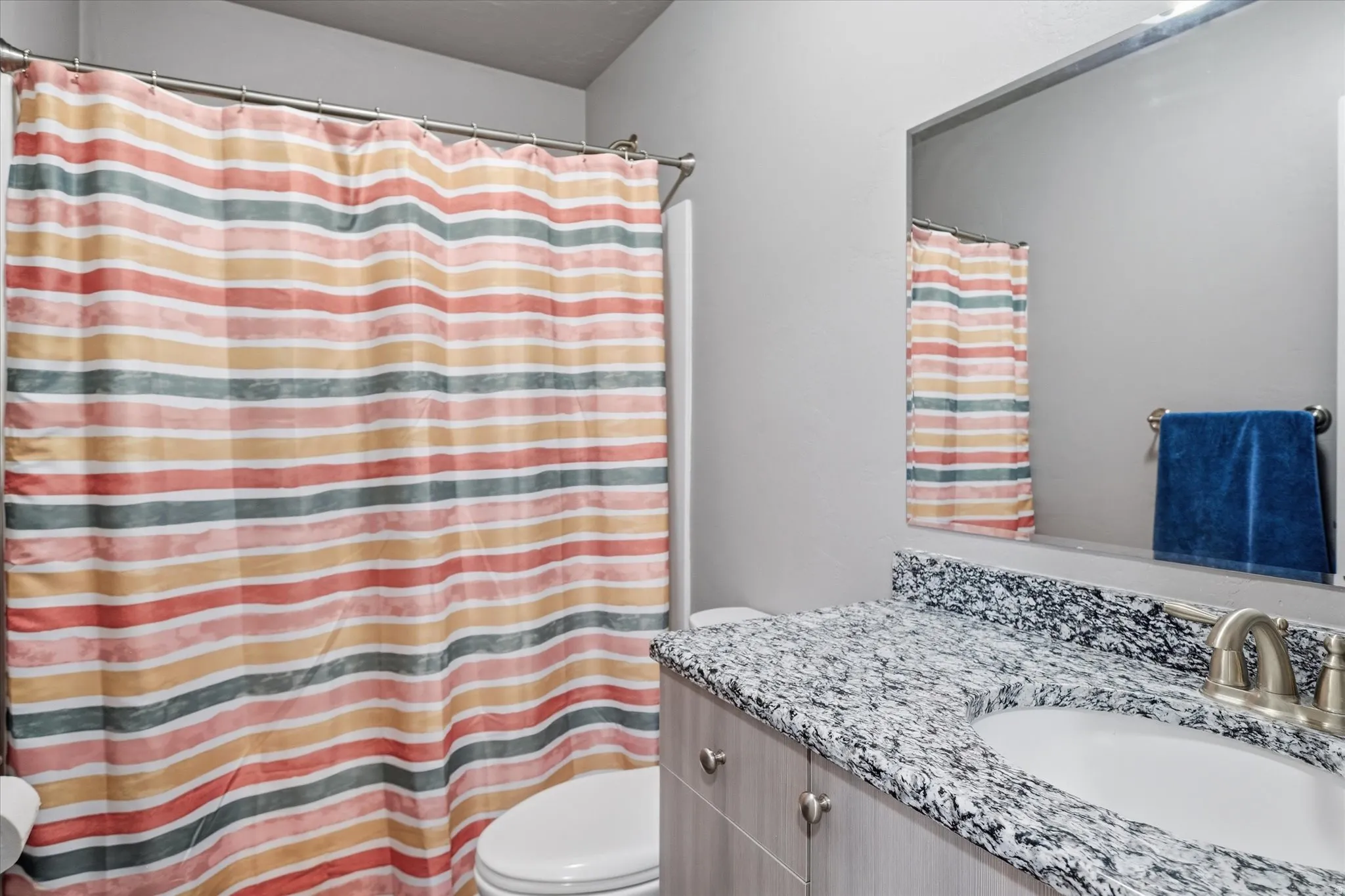 Bathroom with vanity and curtained shower