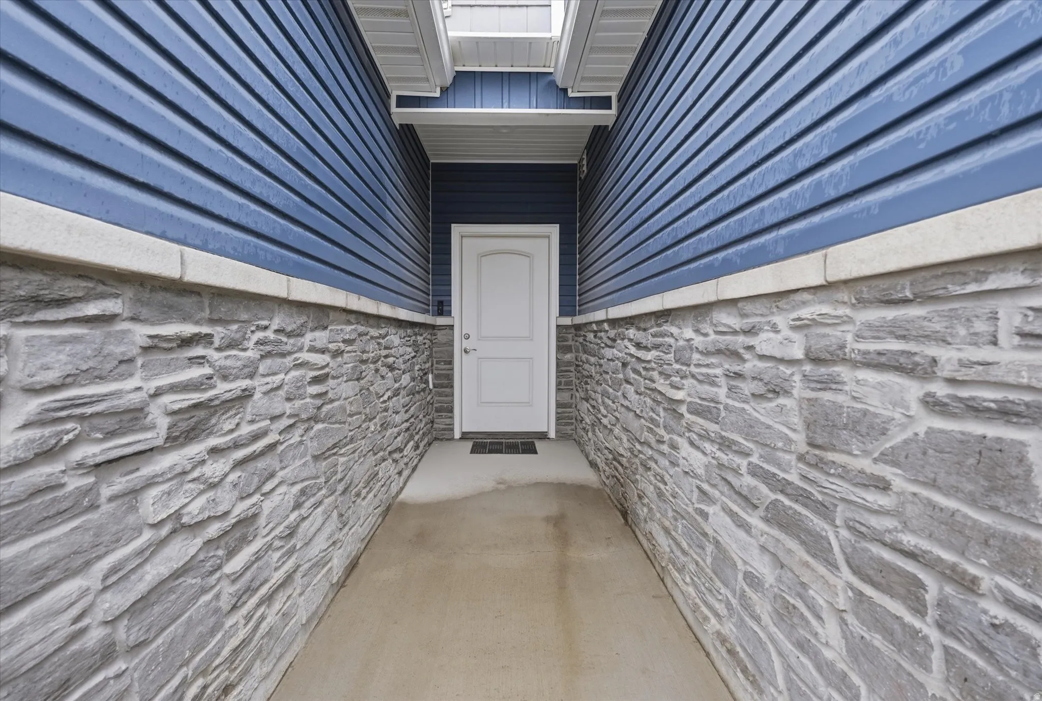 Doorway to property with stone siding