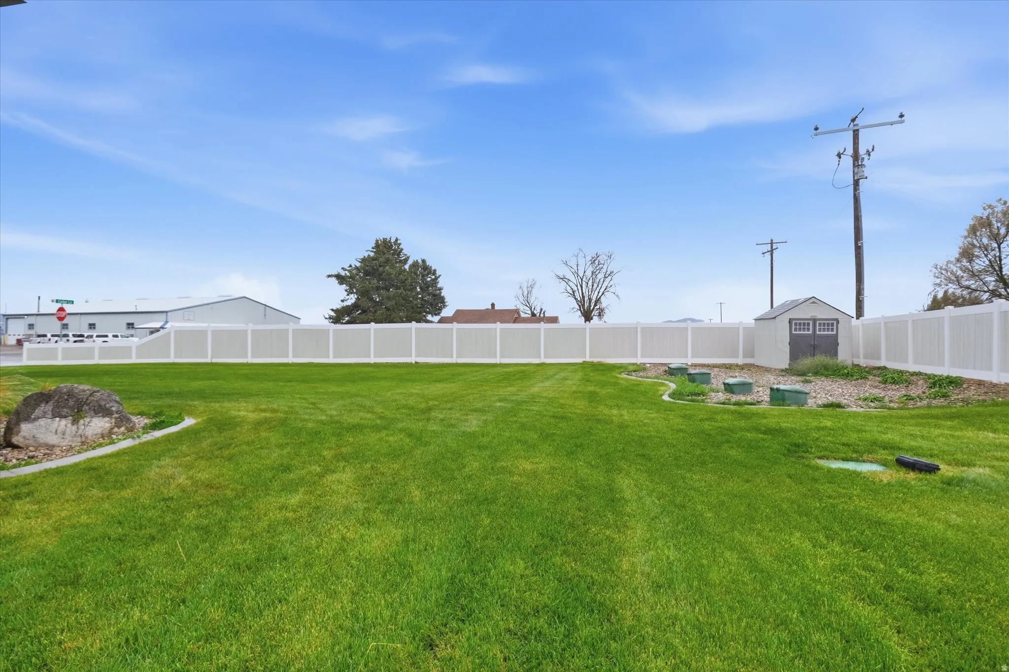 View of partially fenced backyard