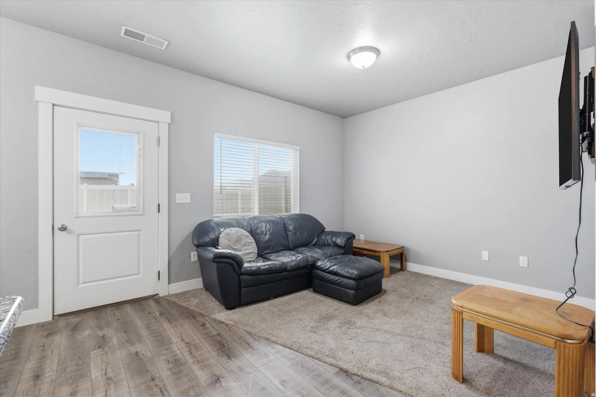 Living area featuring light wood-style flooring and baseboards
