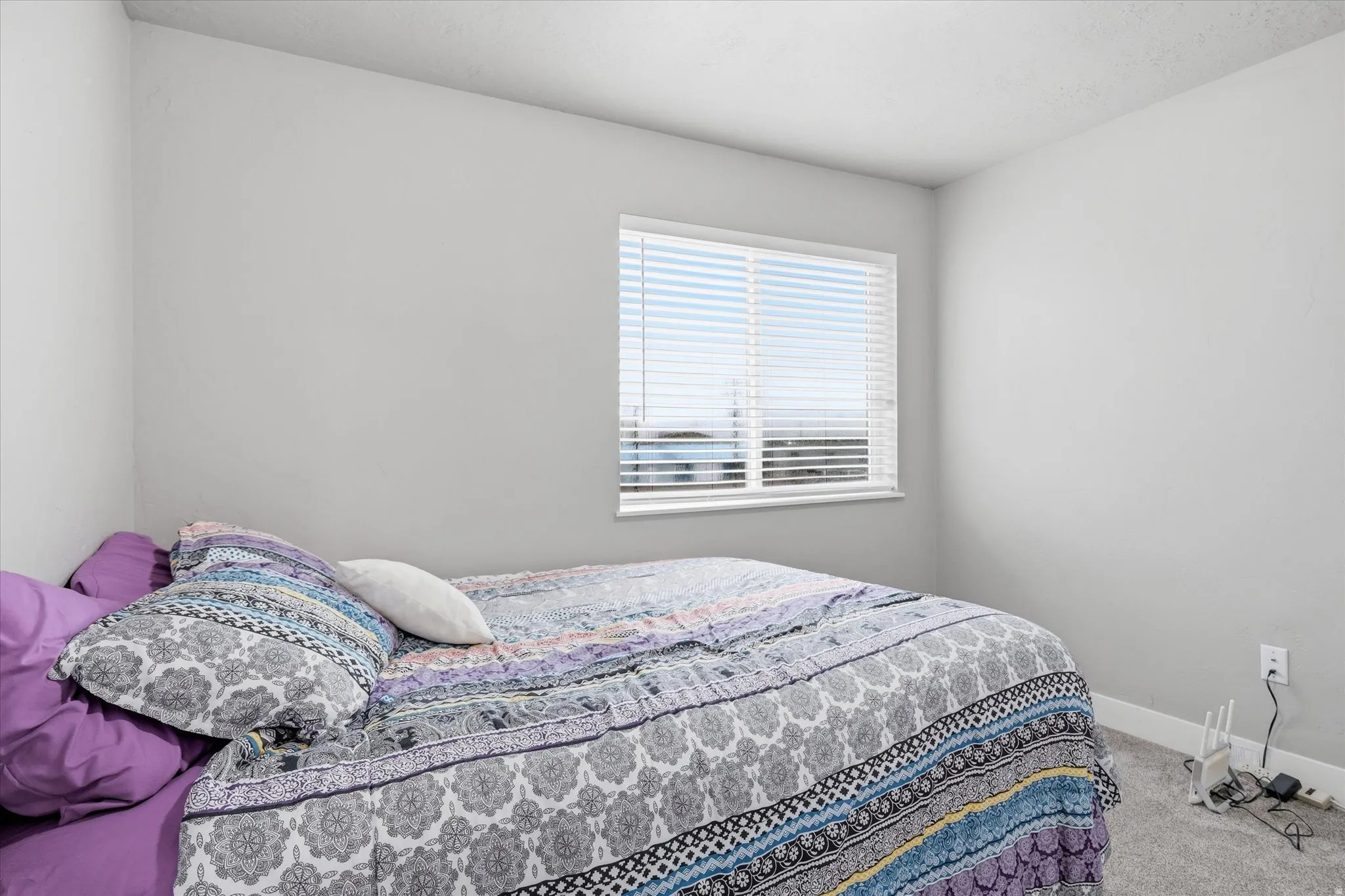 Bedroom featuring carpet floors and baseboards