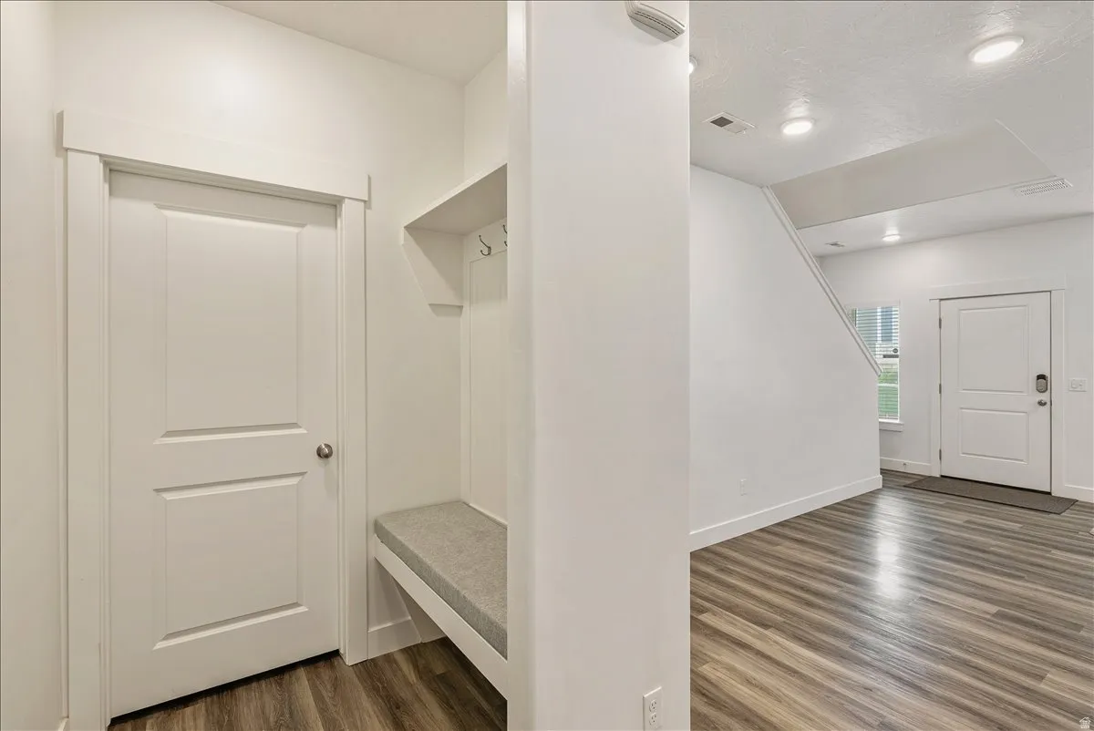 Mudroom with dark wood-style floors, recessed lighting, and a textured ceiling