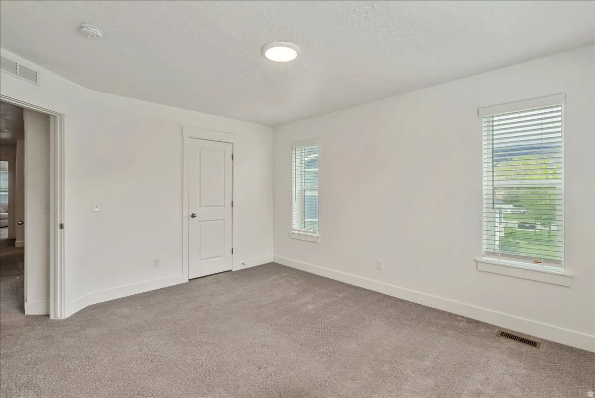 Unfurnished bedroom featuring carpet flooring and a textured ceiling