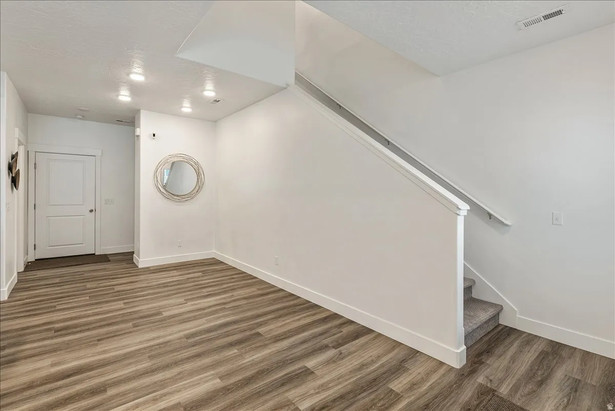 Basement with a textured ceiling and dark wood finished floors