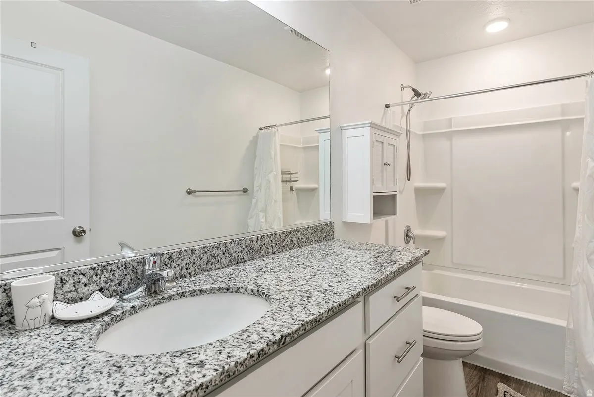 Full bathroom featuring vanity and shower / bath combination with curtain