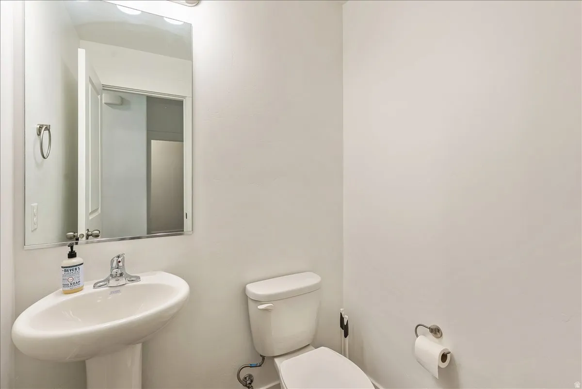 Half bathroom with toilet and a sink