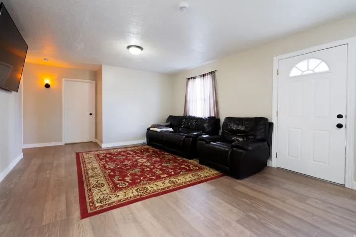 Wood-finish flooring throughout, light-toned wall paint, and white trim