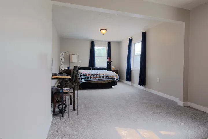 Carpeted flooring, neutral wall paint, recessed lighting, and multiple windows