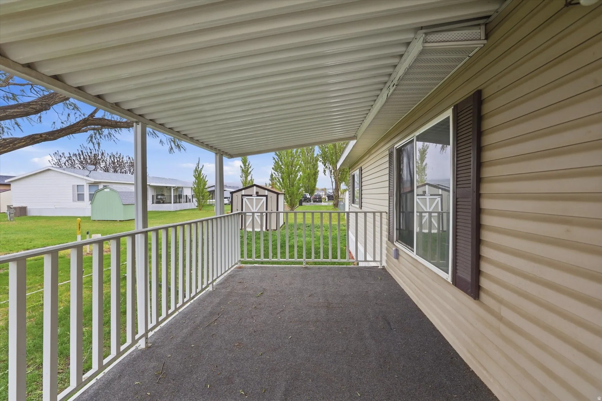 View of patio / terrace with a storage shed and a residential view