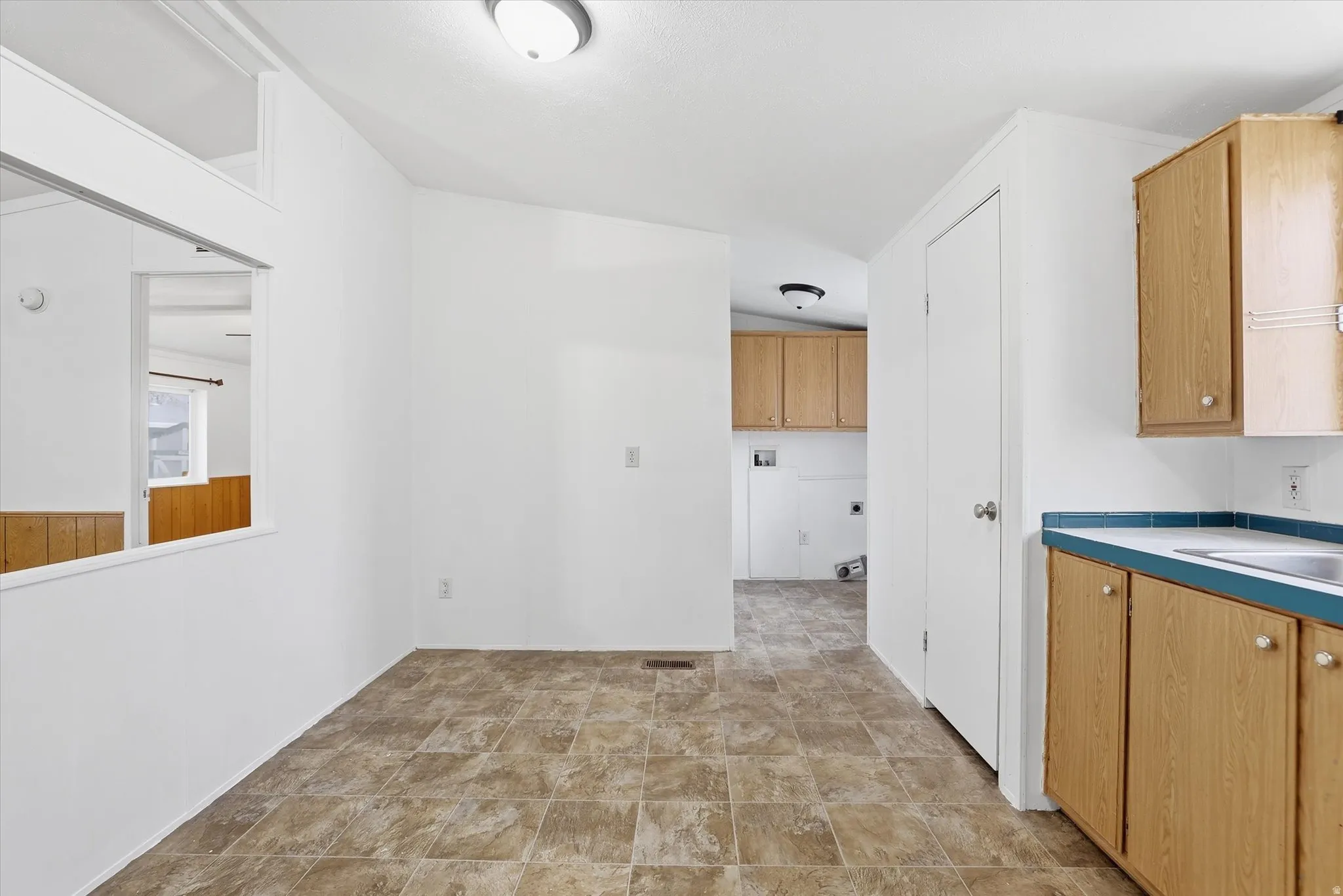 Kitchen featuring stone finish floors and light countertops