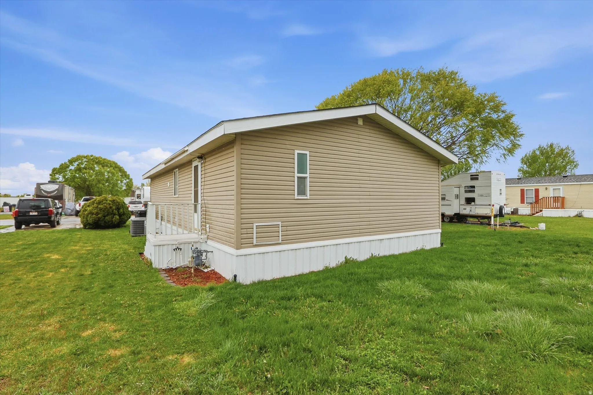 View of property exterior featuring a yard and a central air condition unit