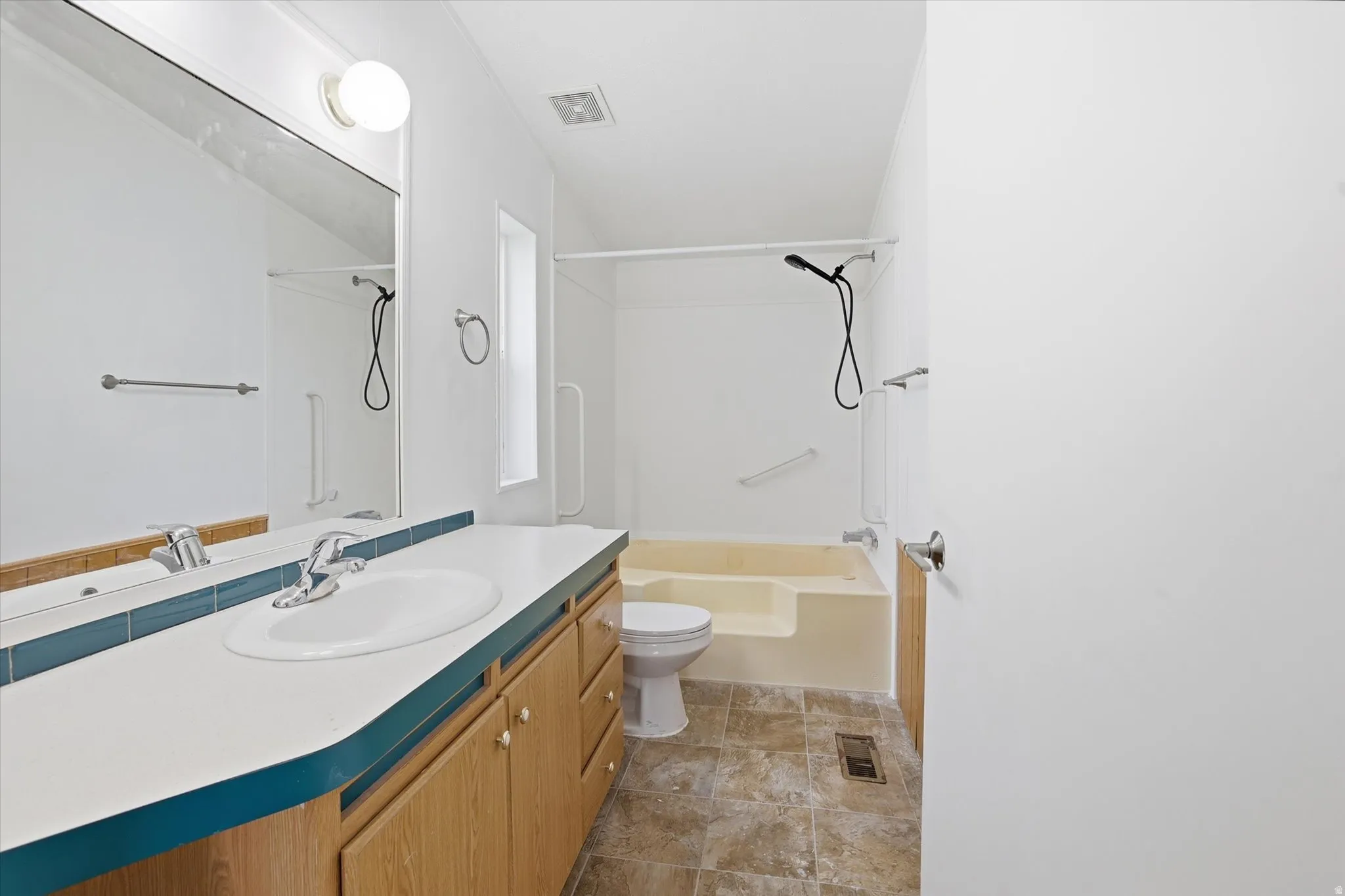 Full bathroom featuring vanity and shower / washtub combination