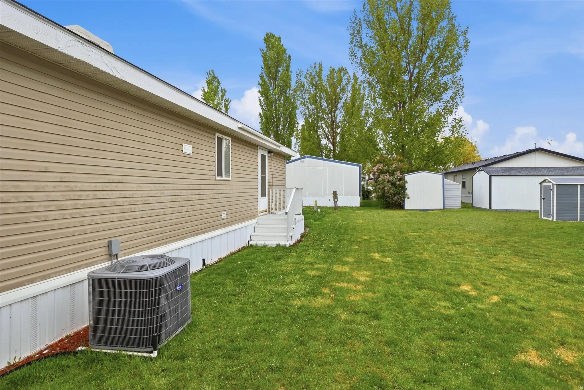 View of green lawn featuring a shed