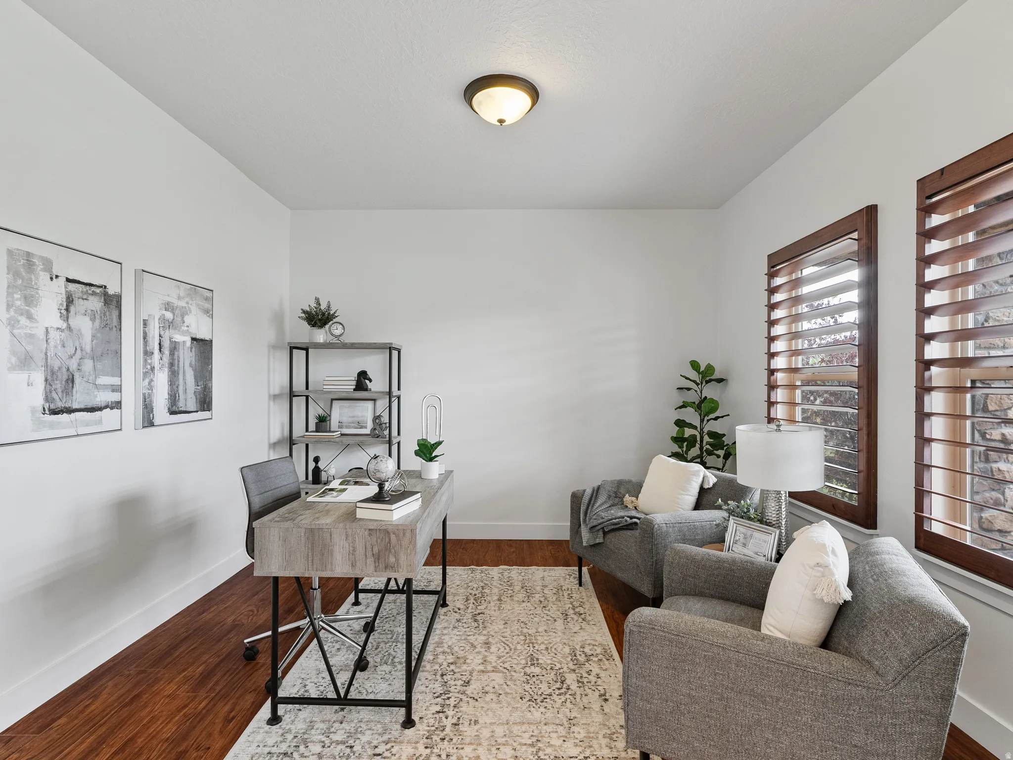 Office space with dark wood-style flooring and baseboards