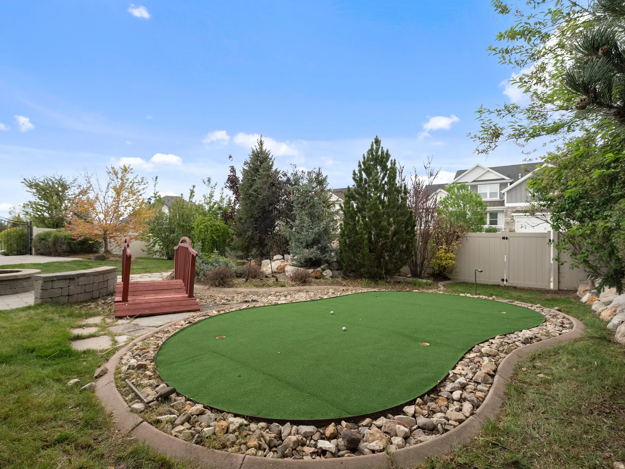 Surrounding community featuring an area to practice putting and a gate