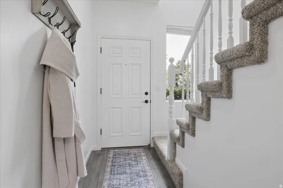 Mudroom featuring dark wood finished floors and baseboards